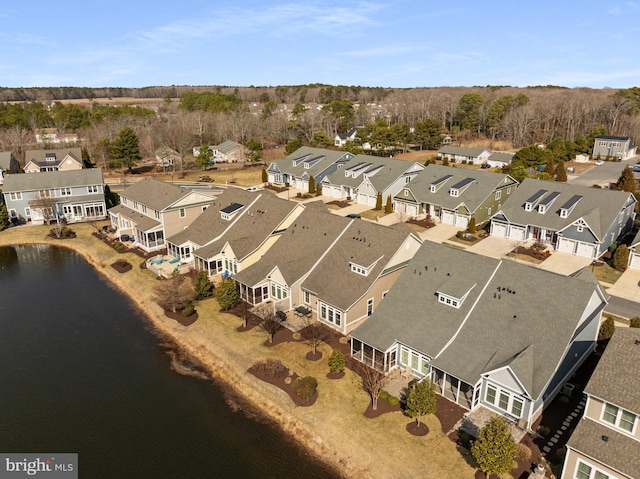 drone / aerial view featuring a residential view and a water view