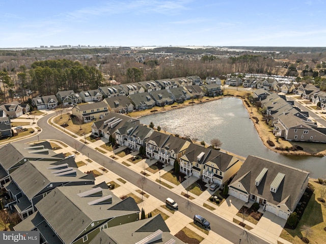 drone / aerial view featuring a residential view and a water view