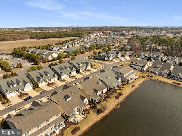 drone / aerial view featuring a residential view and a water view