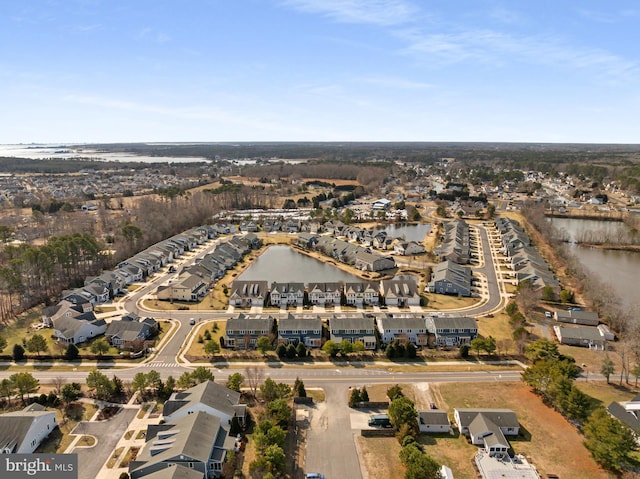 drone / aerial view featuring a water view and a residential view