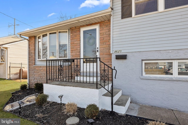 property entrance with stucco siding