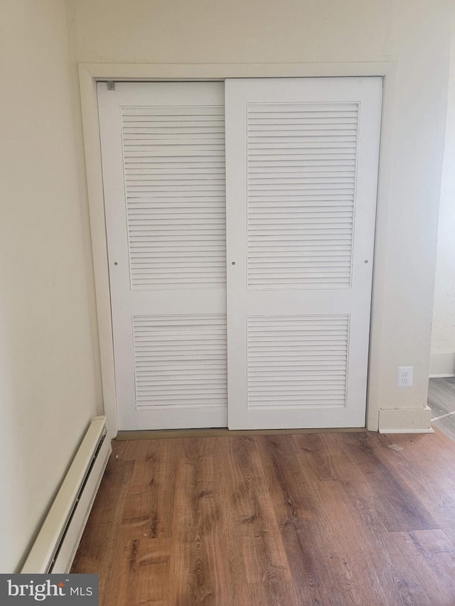 details with a baseboard radiator and wood finished floors