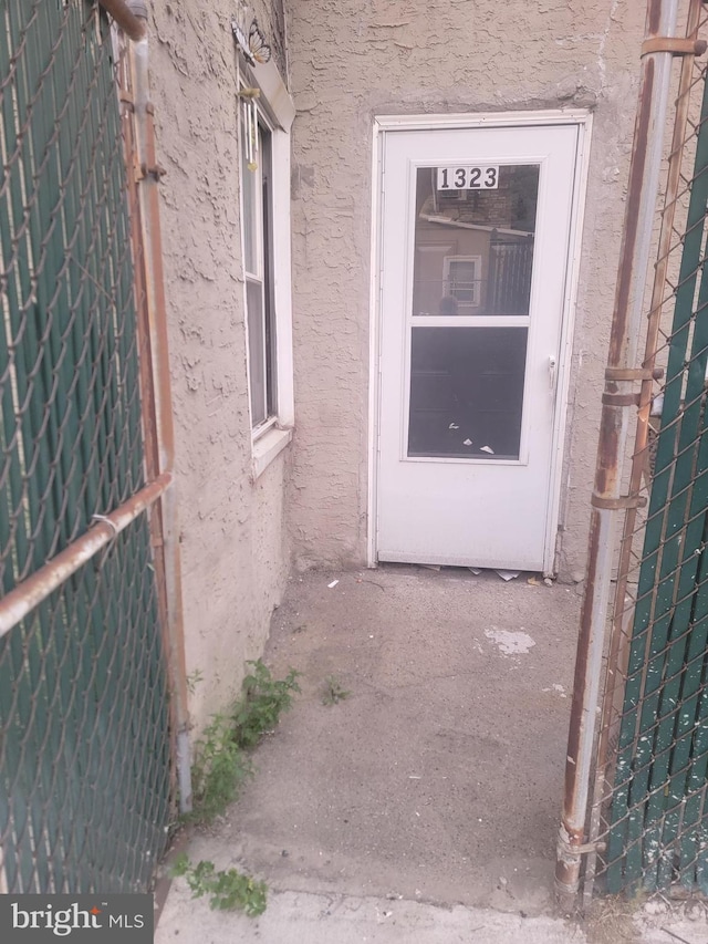 property entrance with stucco siding