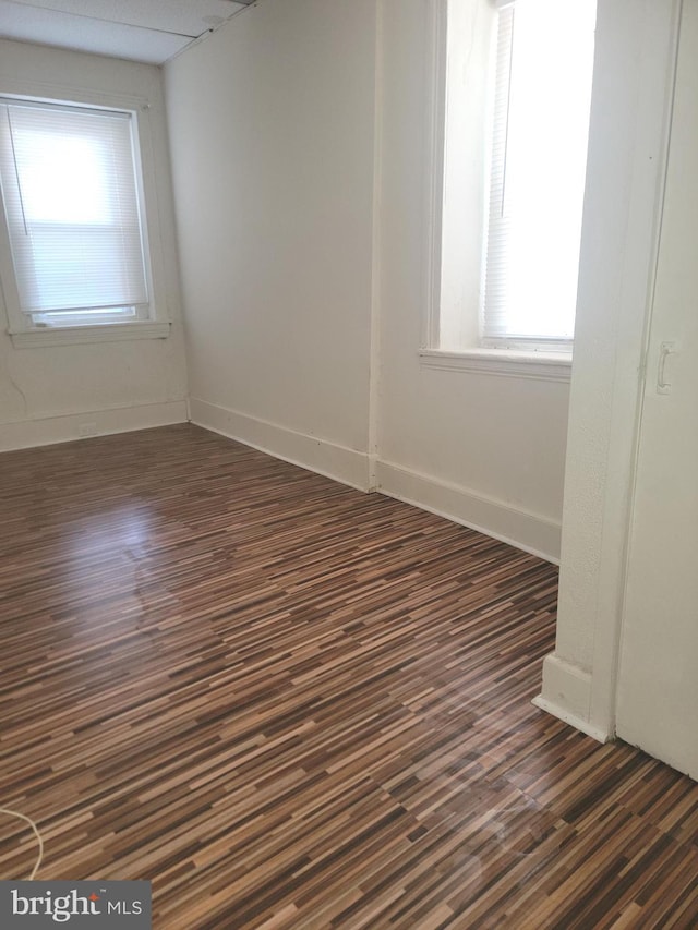 unfurnished room featuring dark wood-style flooring