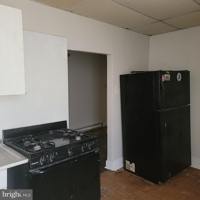 kitchen featuring black appliances and a drop ceiling