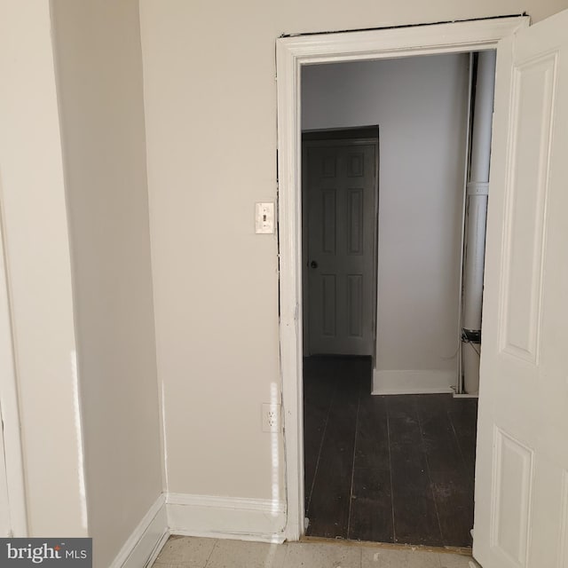 hall featuring wood finished floors and baseboards