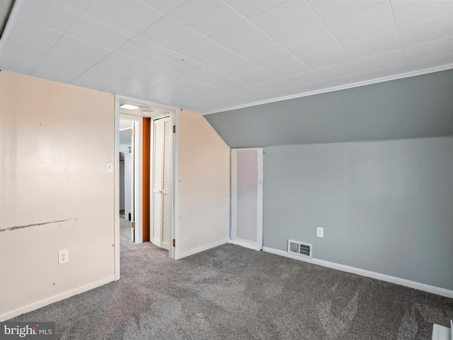 bonus room with carpet, visible vents, vaulted ceiling, and baseboards