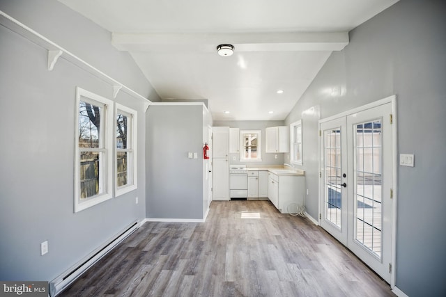 kitchen with french doors, vaulted ceiling with beams, a baseboard radiator, light countertops, and white cabinets