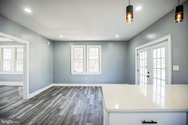 interior space featuring recessed lighting, baseboards, french doors, dark wood-style floors, and decorative light fixtures