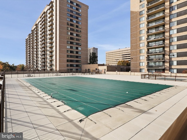 view of pool featuring fence