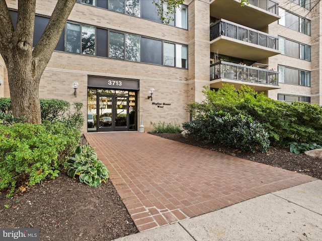 property entrance with french doors and brick siding