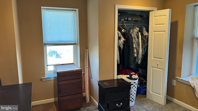 interior space with a closet and baseboards