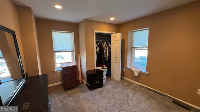 unfurnished bedroom with recessed lighting, baseboards, visible vents, and carpet flooring