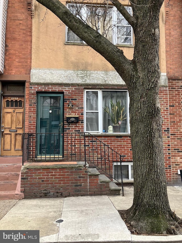 entrance to property with brick siding