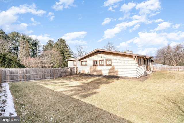 exterior space with a lawn and a fenced backyard