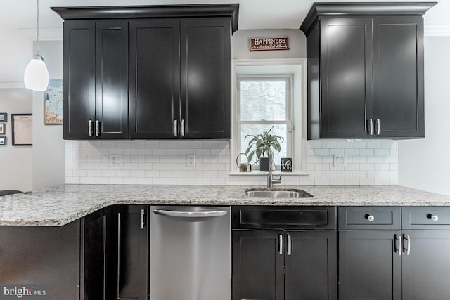 kitchen with a sink, dark cabinetry, decorative backsplash, and dishwasher