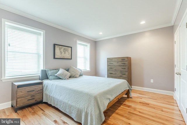 bedroom featuring ornamental molding, recessed lighting, light wood-style floors, and baseboards