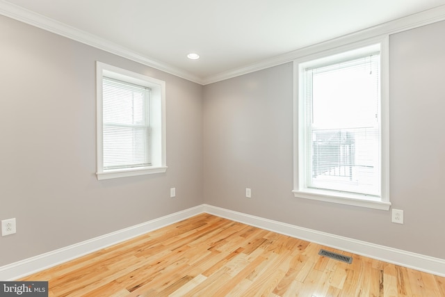 unfurnished room with recessed lighting, visible vents, ornamental molding, wood finished floors, and baseboards