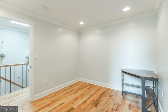 spare room with ornamental molding, recessed lighting, baseboards, and wood finished floors