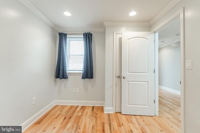 unfurnished bedroom featuring baseboards, wood finished floors, and crown molding