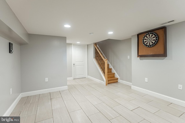 finished below grade area with stairs, recessed lighting, visible vents, and baseboards