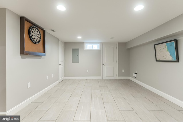 basement with recessed lighting, electric panel, visible vents, and baseboards