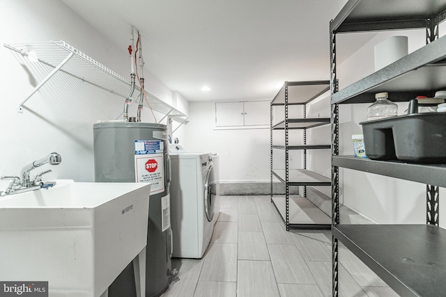 washroom with water heater and a sink