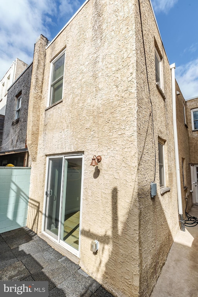 back of house with stucco siding