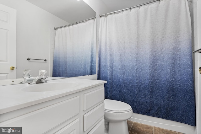 bathroom with tile patterned flooring, vanity, and toilet