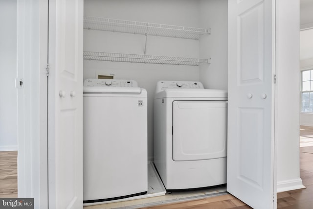 washroom with laundry area, light wood-style flooring, and washer and dryer