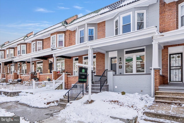 townhome / multi-family property featuring brick siding