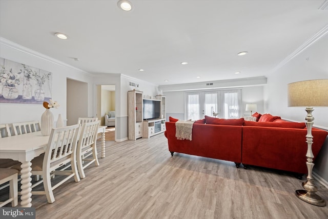 living room featuring french doors, recessed lighting, ornamental molding, light wood-type flooring, and baseboards