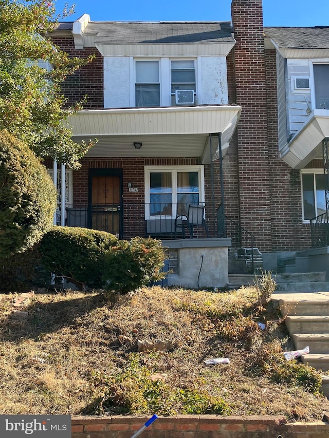 multi unit property with covered porch and brick siding