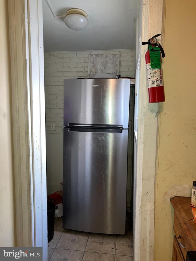 kitchen featuring freestanding refrigerator