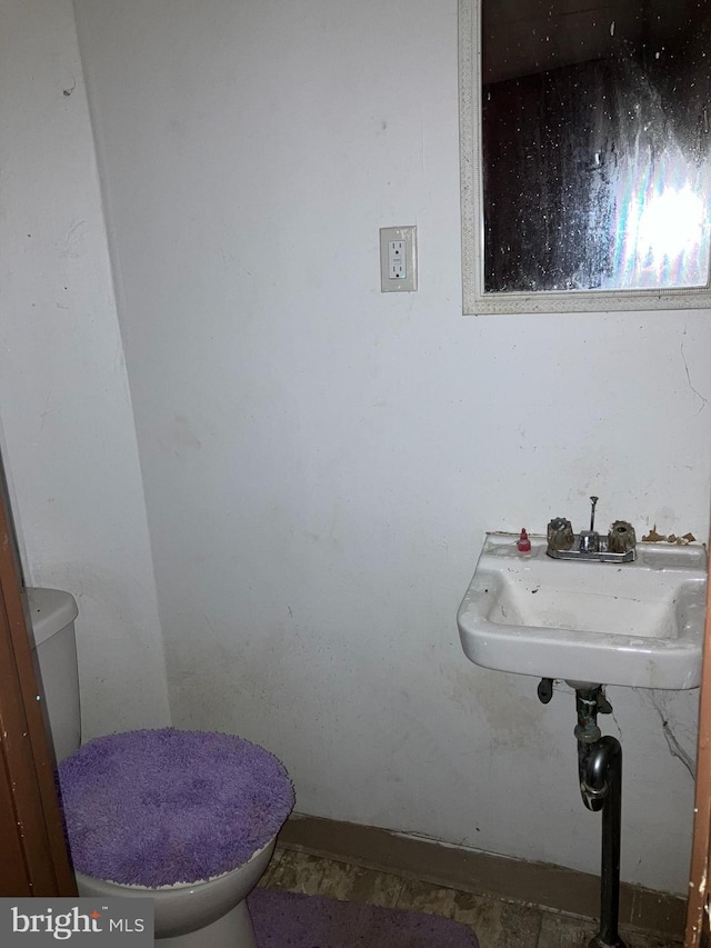 bathroom with toilet and a sink