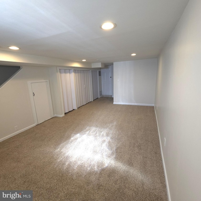 finished below grade area with recessed lighting, light carpet, and baseboards