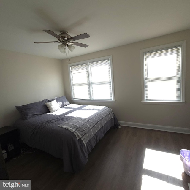 bedroom featuring ceiling fan, wood finished floors, and baseboards