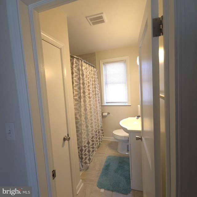 full bathroom featuring visible vents, a shower with shower curtain, toilet, vanity, and tile patterned floors