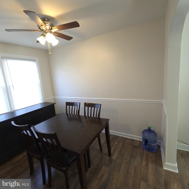 dining space with baseboards and wood finished floors