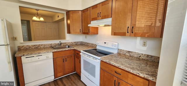 kitchen featuring light stone countertops, white appliances, under cabinet range hood, and a sink