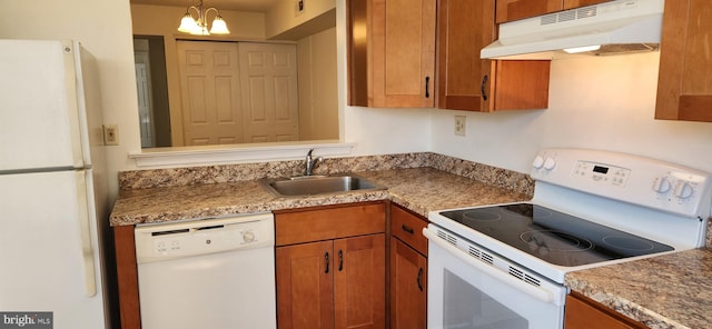 kitchen with light countertops, brown cabinetry, a sink, white appliances, and under cabinet range hood