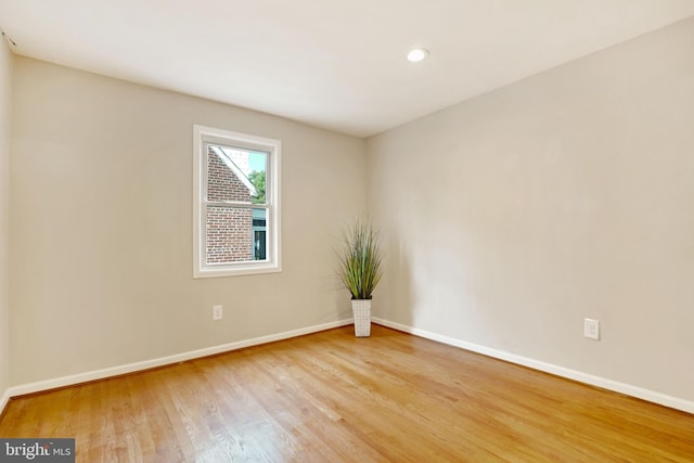 unfurnished room with recessed lighting, light wood-style flooring, and baseboards