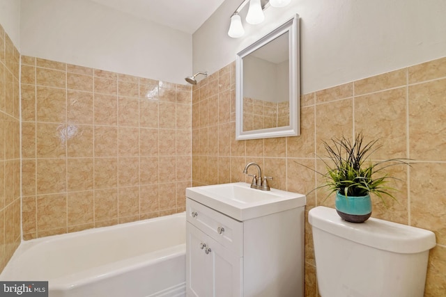 bathroom with bathtub / shower combination, tile walls, toilet, and vanity