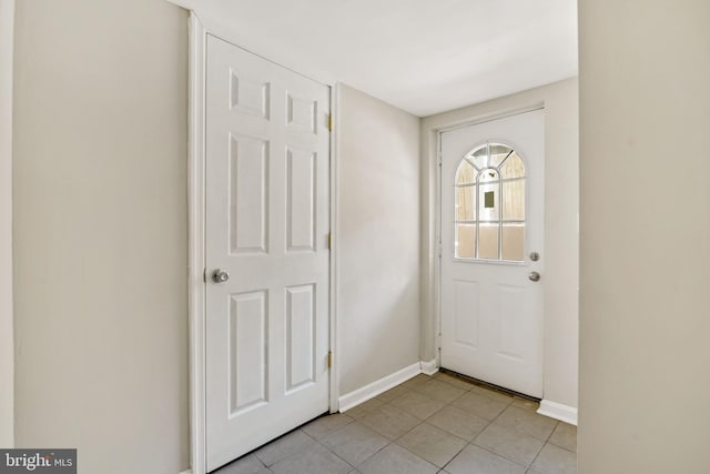 foyer entrance with baseboards and light tile patterned flooring