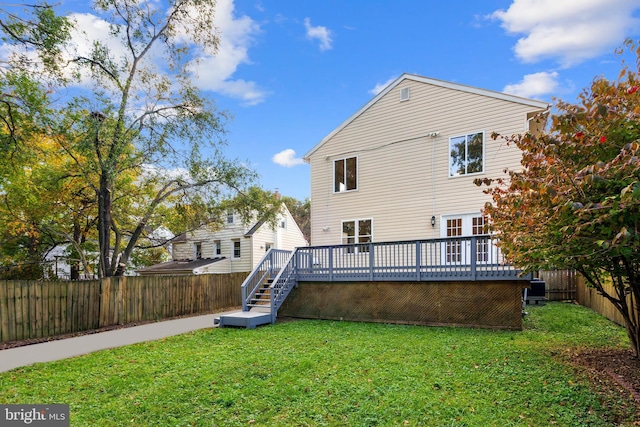 rear view of property with stairs, a yard, a fenced backyard, and a wooden deck