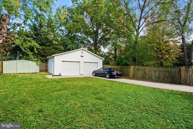 view of yard with a storage unit, a detached garage, fence, and an outdoor structure