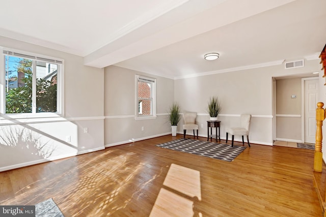 sitting room featuring a wealth of natural light, baseboards, visible vents, and wood finished floors