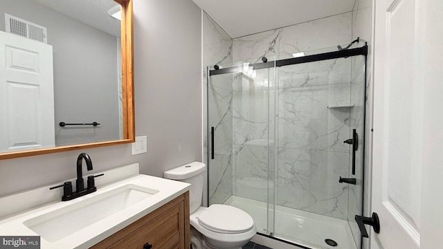 bathroom featuring toilet, a marble finish shower, vanity, and visible vents