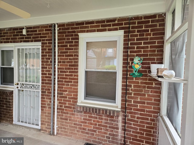 view of exterior entry with brick siding