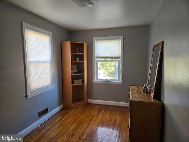 unfurnished bedroom with baseboards and wood finished floors